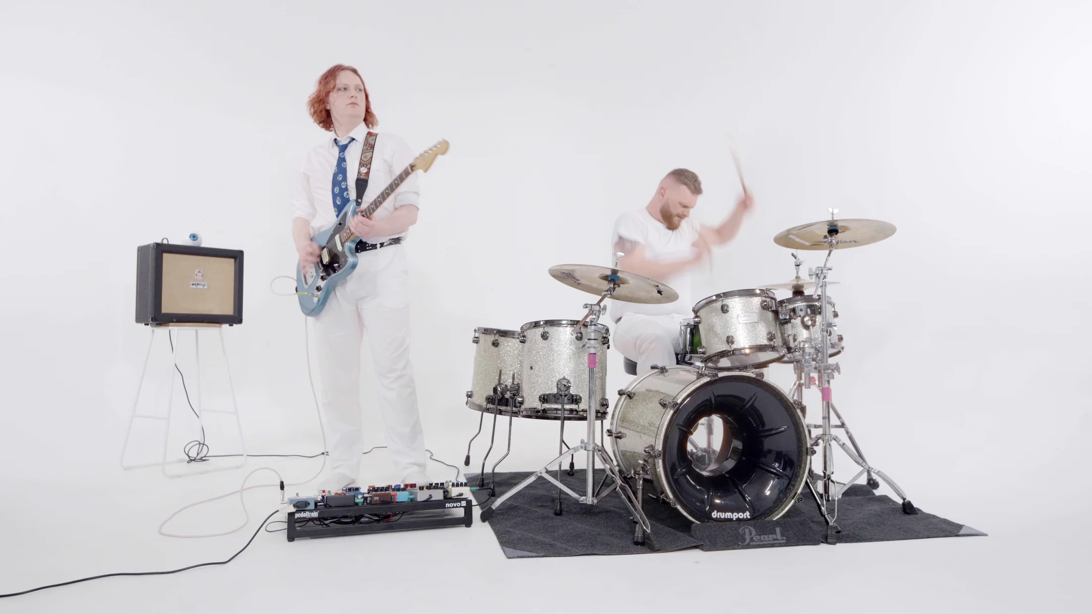 Prayers Electric performing together in an all-white studio