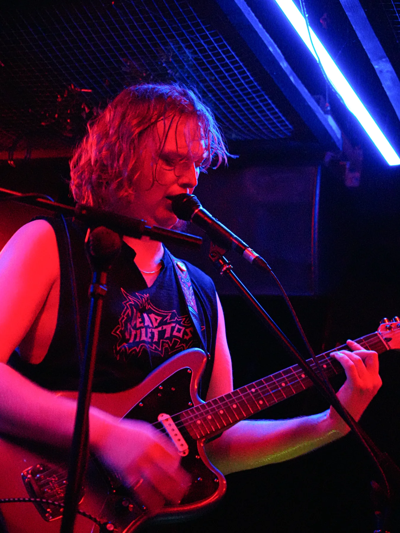 Jem singing and playing guitar under the Stage and Radio lights