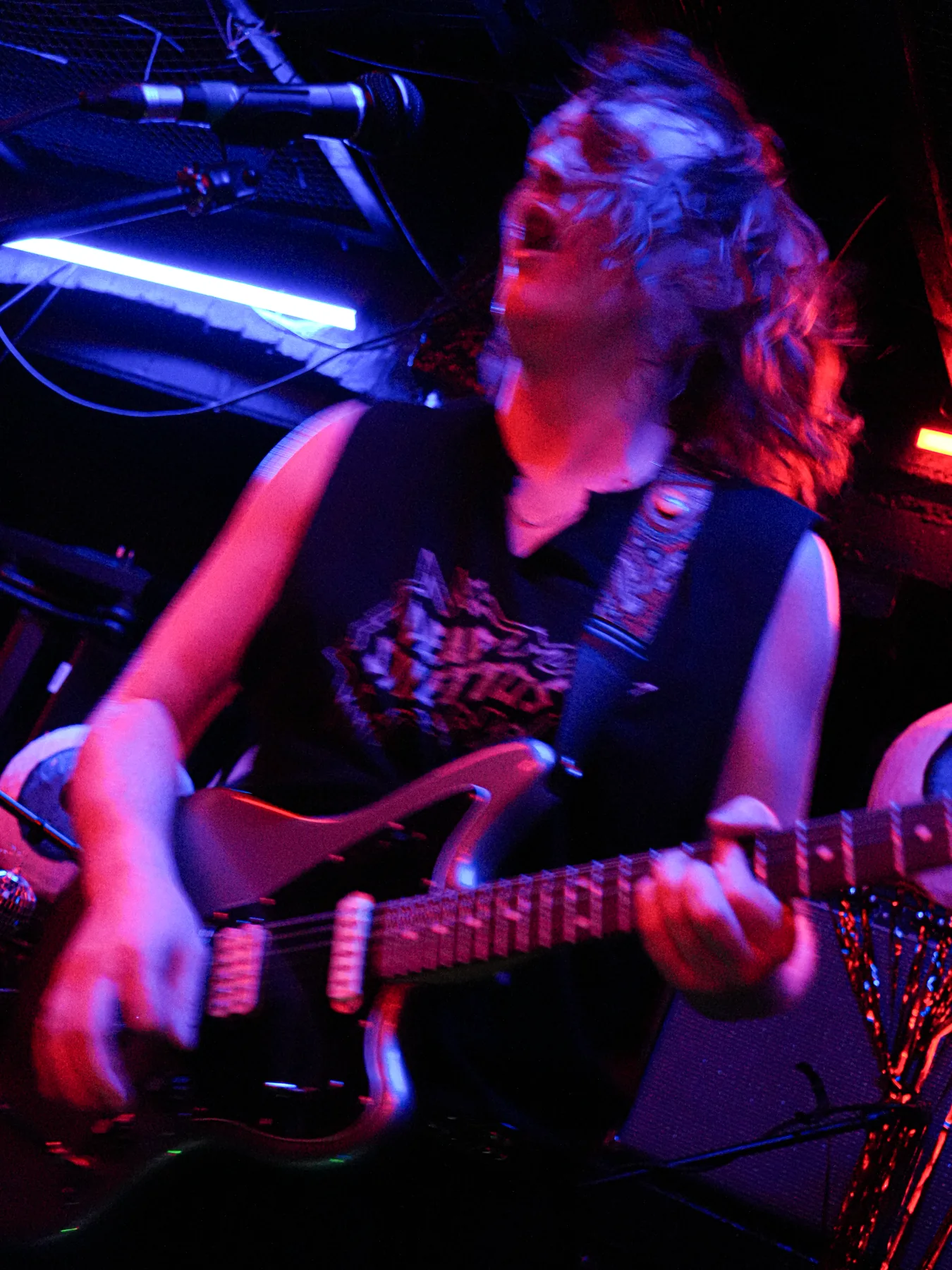 Jem playing guitar in motion at Stage and Radio